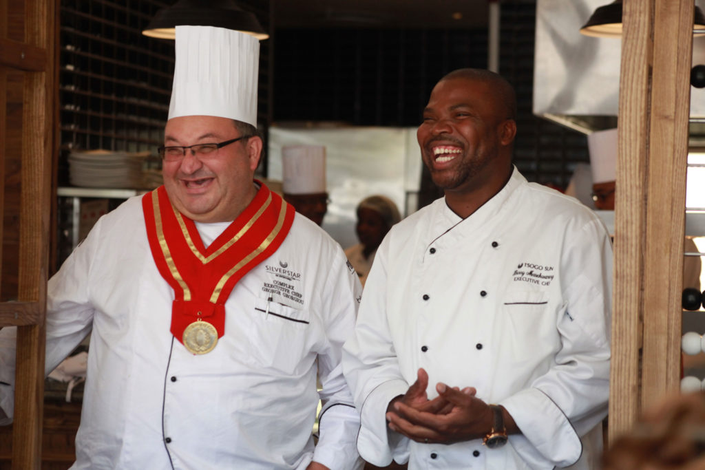 Chef Benny laughing alongside another chef